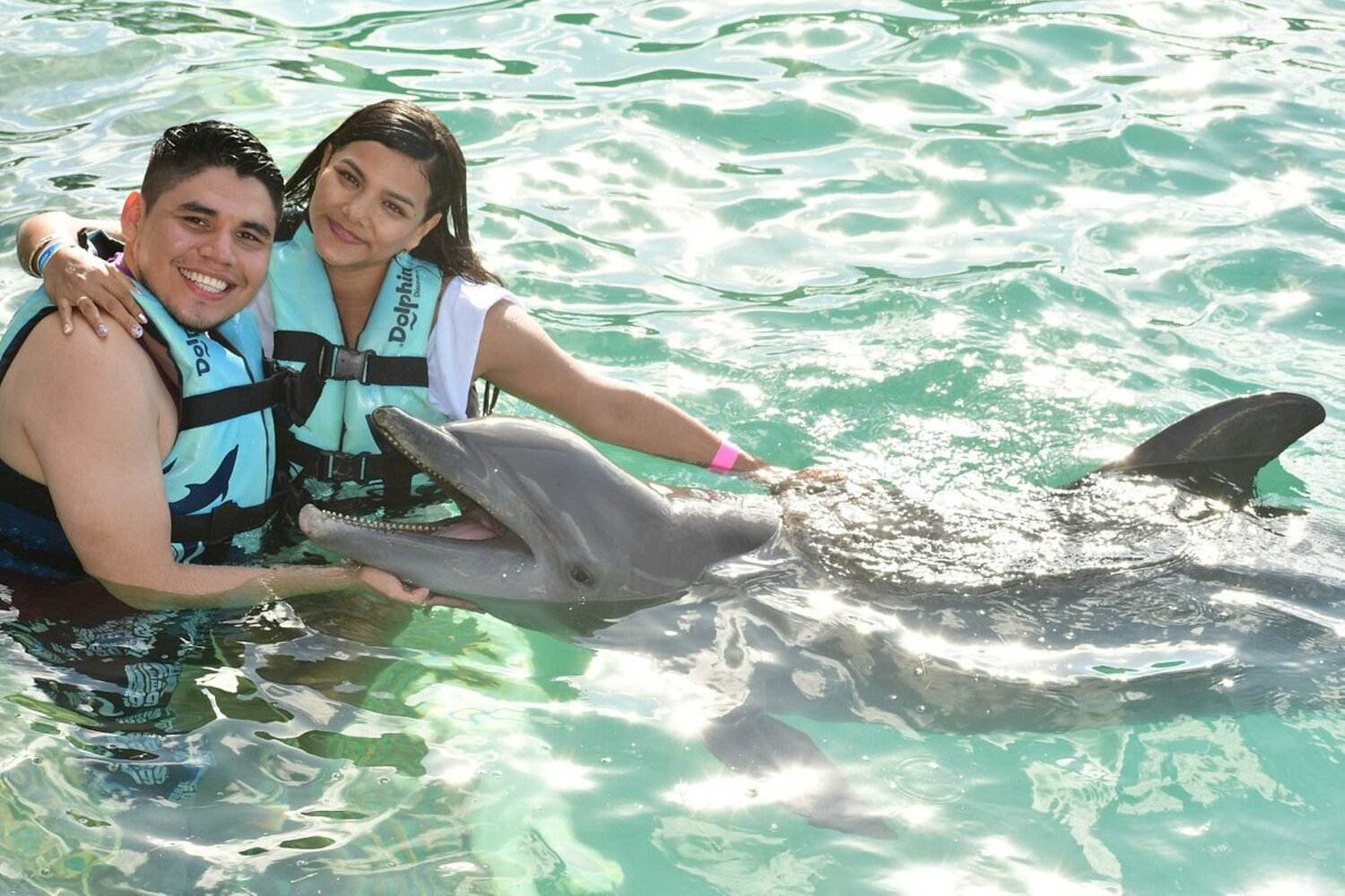 couple in a dolphin encounter in cancun